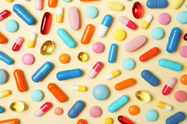 Many different pills on color background, top view - Фото, изображение