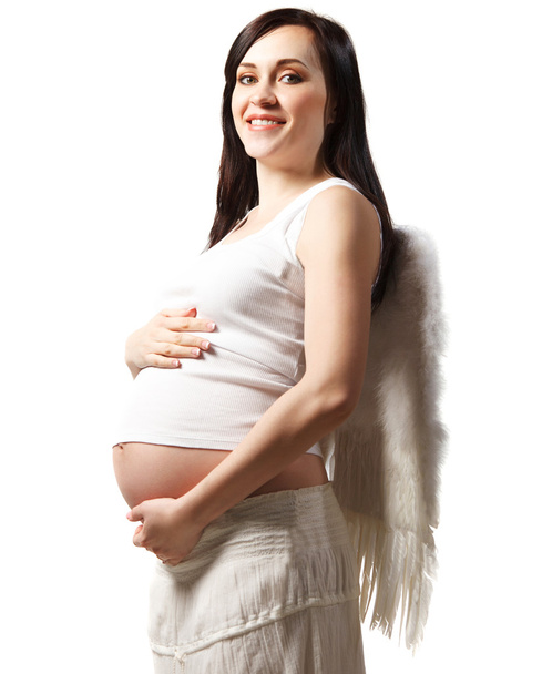 Happy young pregnant woman in white. Isolated on white - Foto, afbeelding