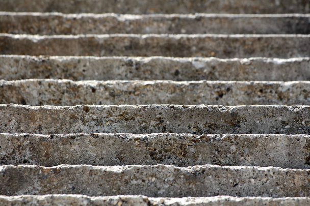Old dilapidated cracked concrete steps wallpaper texture background on warm sunny summer day - Photo, Image