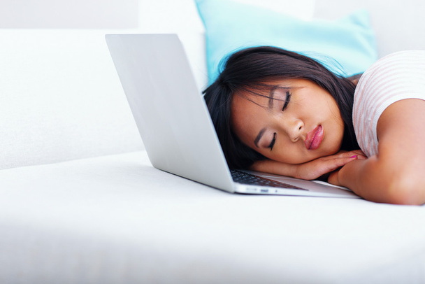 Young asian woman has fallen asleep while using laptop - Фото, изображение