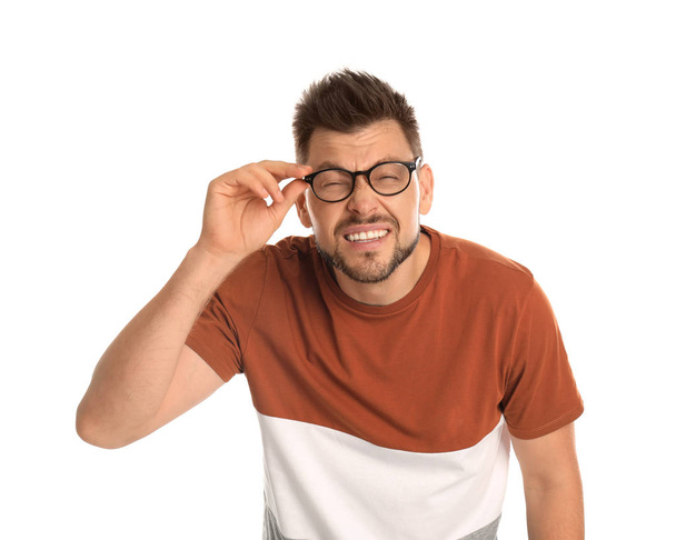 Man with vision problems wearing glasses on white background - Фото, изображение