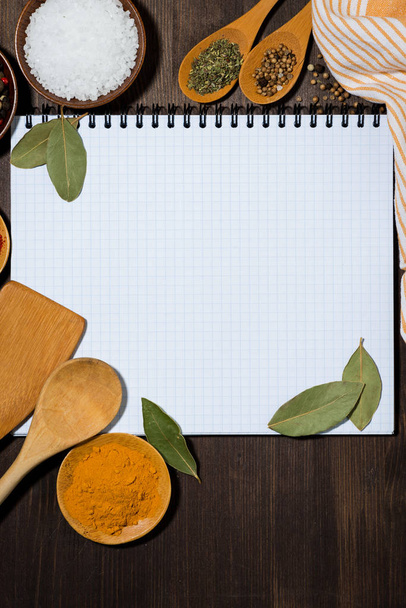 open notebook for writing recipes, kitchen spoons and spices  - Foto, Imagen