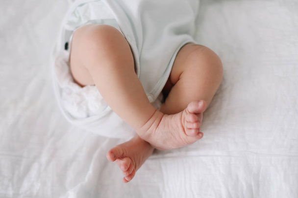Newborn baby feet. Tiny baby feet closeup. Happy Family concept.  - 写真・画像