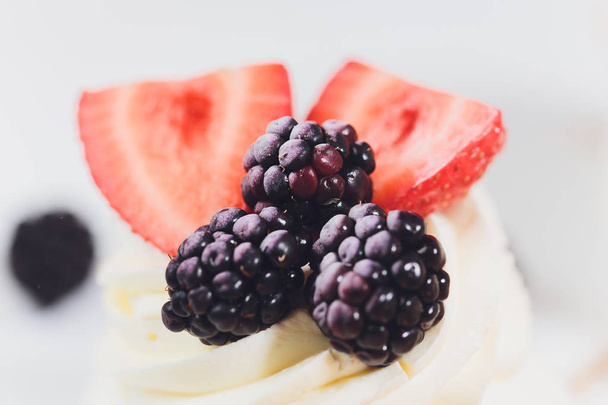 Dessert with berries on a meringue with cream. - Foto, Imagem