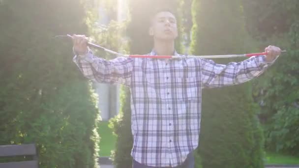 Young visually impaired asian with a cane in the park - Video
