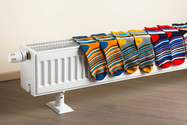 colorful socks are being dry on the radiator - Photo, Image