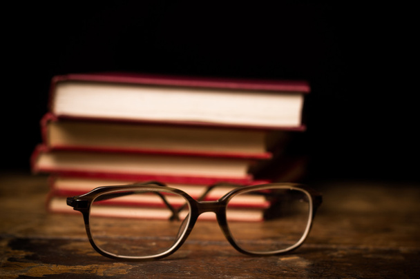 Stack of books with a pair of glasses - Foto, Imagen