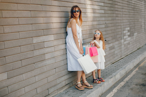 Mother and daughter with shopping bag in a city - Foto, imagen