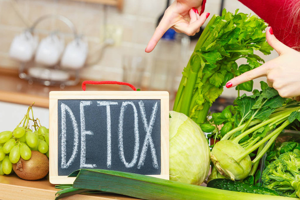 Woman having green diet vegetables, detox sign - Фото, изображение