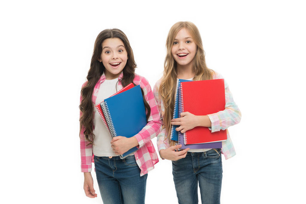 Pads perfect for the academic use. Cute small school children holding note pads. Adorable little girls with colorful writing pads. Keeping notes in durable and designer pads - Photo, Image