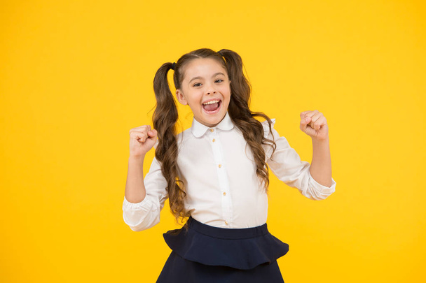 Celebrate knowledge day. Girl pupil on yellow background. Back to school. Student little kid. Emotional school girl. Successful graduation. Happy childrens day. Positive vibes. School life concept - Zdjęcie, obraz