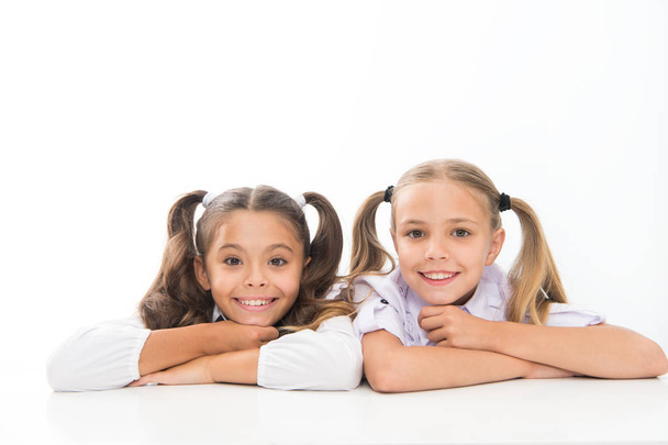 Beautiful and smart. School girls in pigtails. Cute little girls smiling isolated on white. Happy small girls at school. Adorable baby girls in class - Foto, imagen