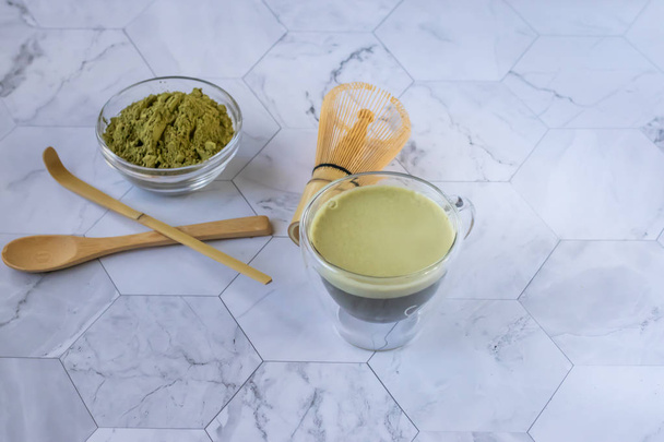 Matcha green tea with froth is a tasty way to enjoy energy and health benefits. Matcha is a green tea leaf powder filled with antioxidants. Horizontal orientation - Zdjęcie, obraz