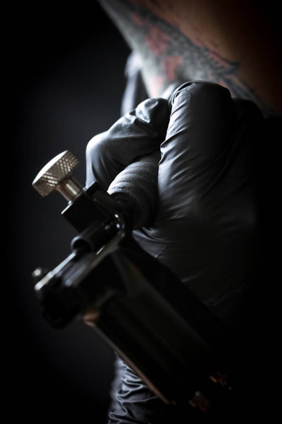 Tätowiererin macht Tätowierung auf dem Arm eines Mannes - Foto, Bild