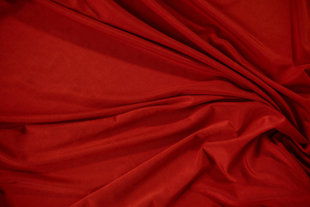 Background image of crumpled fabric. Red cloth - 写真・画像