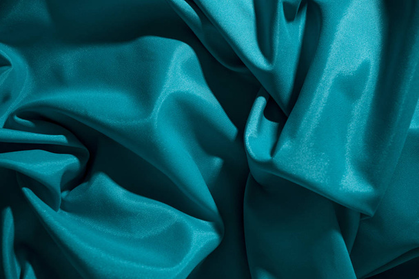 Background image of crumpled fabric. Blue silk - Фото, изображение