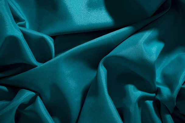 Background image of crumpled fabric. Blue silk - Zdjęcie, obraz