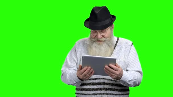 Ηλικιωμένος άνδρας σε καπέλο κρατώντας δισκίο υπολογιστή. - Πλάνα, βίντεο