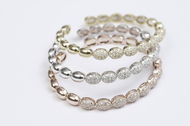 Set of three colored gold and diamond bracelets. - Photo, Image