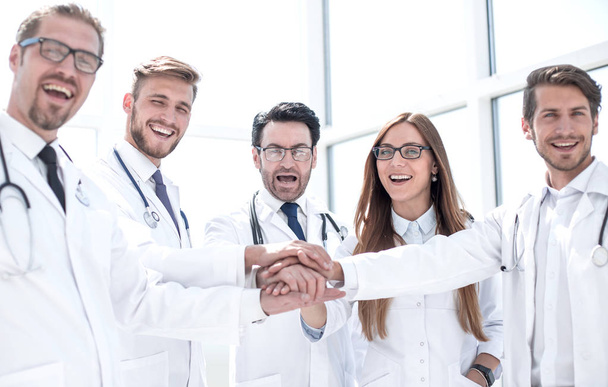 group of doctors with their hands folded together - Photo, image