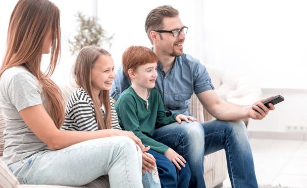 family watches TV in the modern living room - Foto, imagen