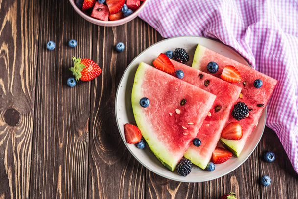 Fresh Berry mix with Strawberry, Blueberry, Watermelon and Black berry on a wooden background. Cut watermelon. Juicy and fresh watermelon - Foto, immagini