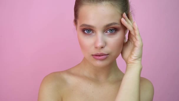 Beautiful girl at studio background, beauty concept, at pink background - Felvétel, videó