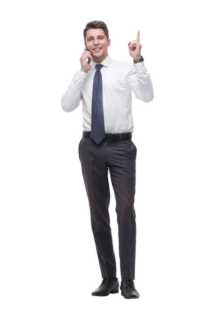 attentive young businessman talking on mobile phone. isolated on white - Foto, Imagem