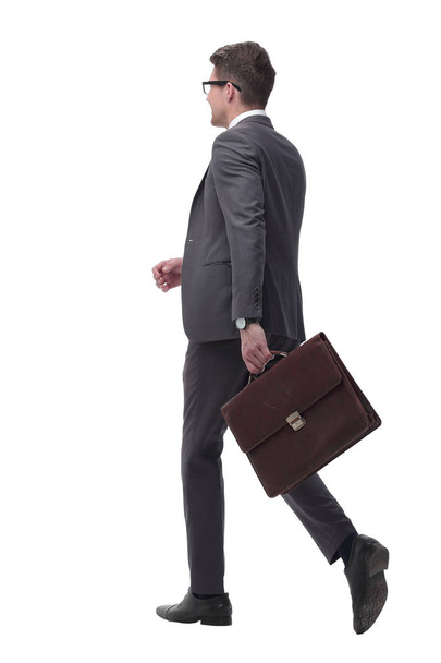 side view. confident businessman with leather briefcase stepping forward - Φωτογραφία, εικόνα