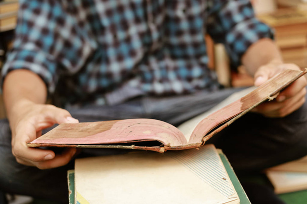 guy in a plaid shirt is studying old books - Photo, Image