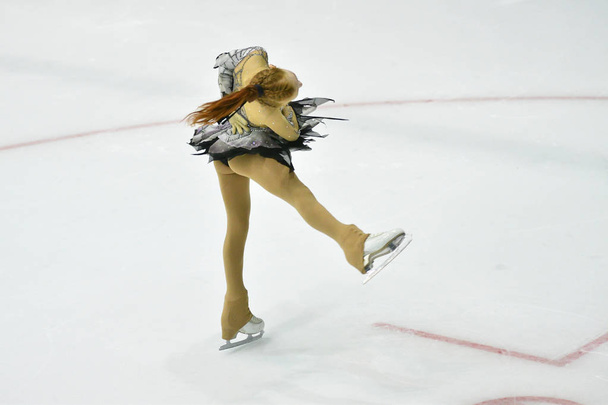 Girl skater skates on ice sports arena - Photo, Image