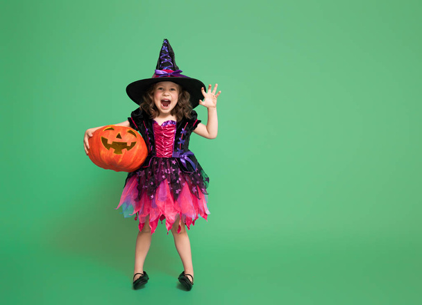 little witch on green background - Фото, зображення