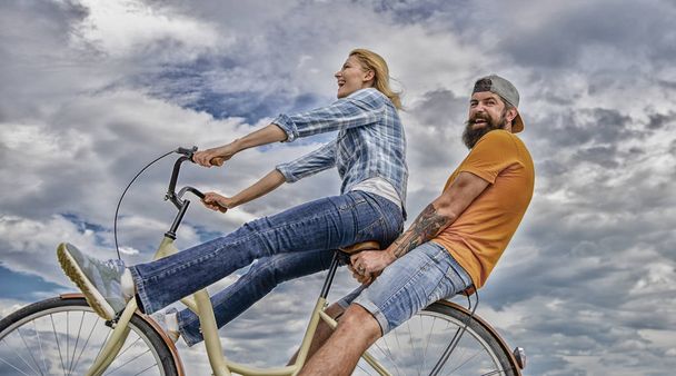 Date ideas. Man and woman rent bike to discover city. Bike rental or bike hire for short periods of time. Couple with bicycle romantic date sky background. Couple in love date outdoors cycling - Photo, Image
