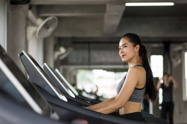 Asian woman run on treadmill in gym - Photo, image
