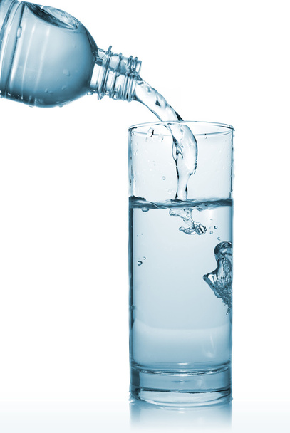 Water pouring into glass from bottle - Photo, Image