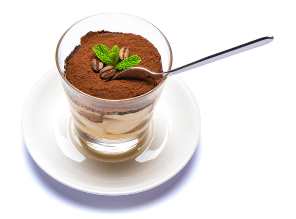 Classic tiramisu dessert in a glass cup on the plate on white background with clipping path - Foto, afbeelding
