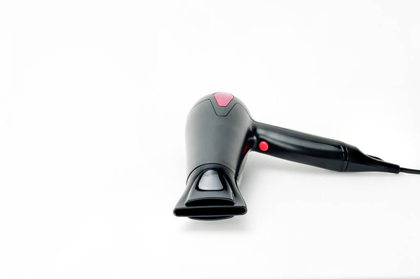 Hair dryer on white mat background with copy space - Fotó, kép