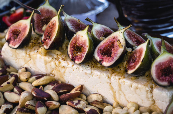 Gourmet natural food. Gourmet parma cheese with caramelized figs. Fruit of high gastronomy, for social events like weddings and parties. - Photo, Image