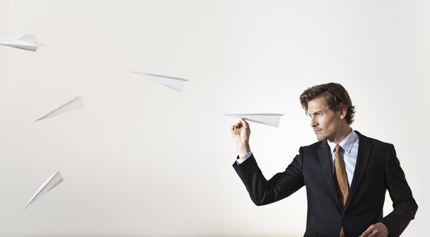 Бизнесмен бросает бумажные самолеты в цель
 - Фото, изображение