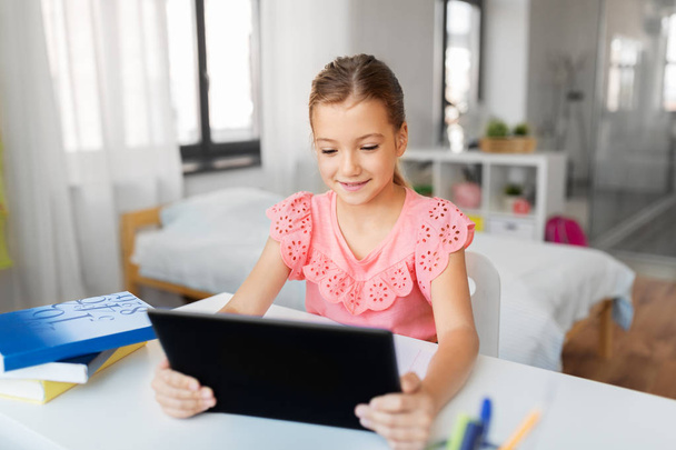 student girl using tablet computer at home - Fotó, kép