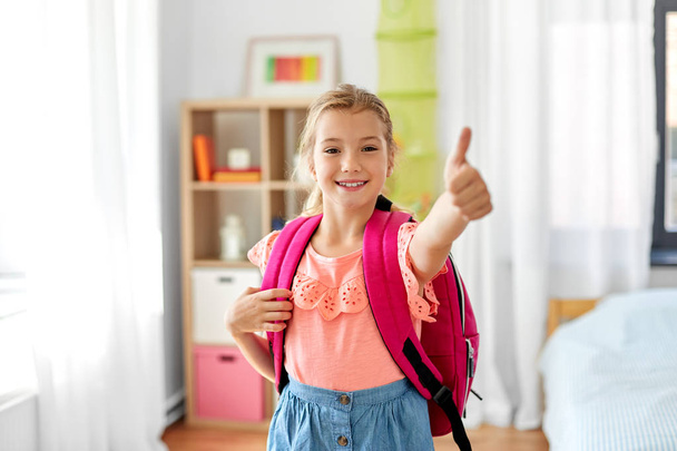 student girl with school bag showing thumbs up - Φωτογραφία, εικόνα
