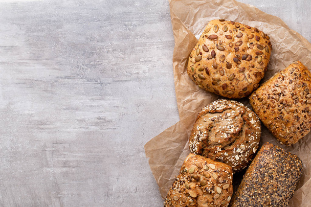 Assortment of baked bread on wooden table background. - Φωτογραφία, εικόνα