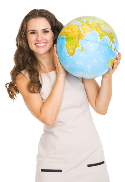 Smiling young woman looking out from earth globe - Фото, зображення
