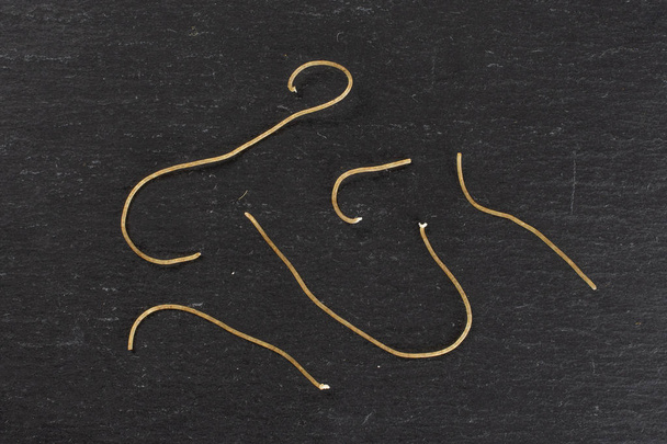 Raw thin noodles on grey stone - Φωτογραφία, εικόνα