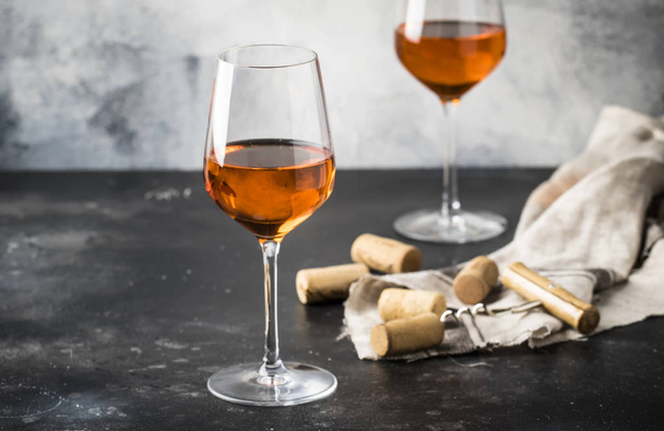 Orange wine in big wine glass, fashionable modern drink, gray counter background, copy space, selective focus - Foto, Imagem