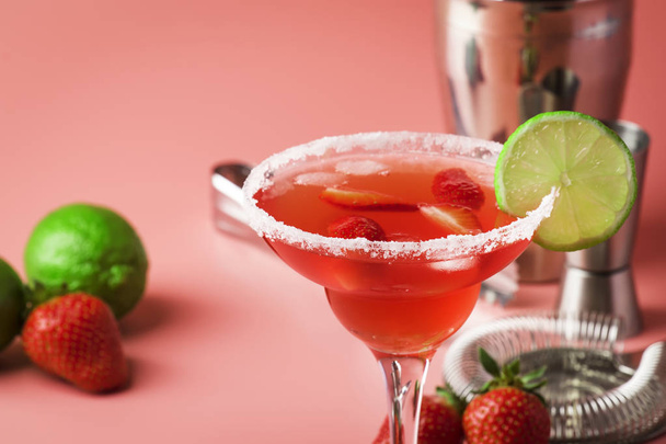 Strawberry red margarita alcoholic cocktail with tequila, liqueur, berries, lime juice, sugar and ice, pink background, copy space - Photo, Image