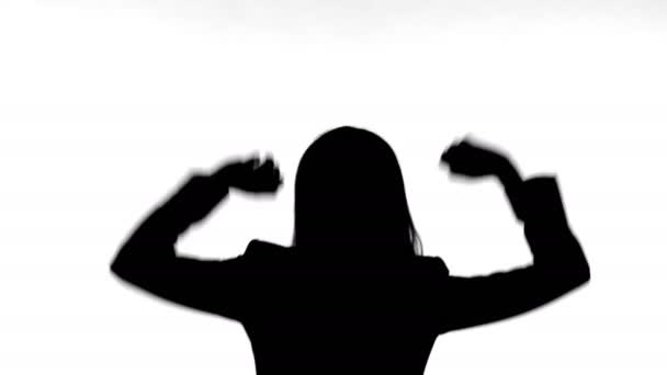 Silhouette of Woman Dancing Alone Against White Background - Video