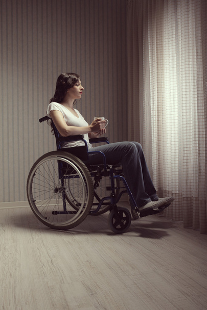 Sad woman sitting on wheelchair - Фото, изображение
