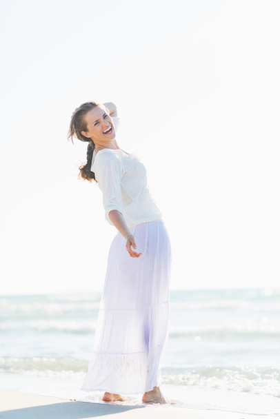 Portrait of smiling young woman on beach - Zdjęcie, obraz