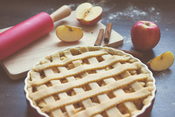 Traditional homemade apple pie and ingredients on wooden backgro - Photo, image